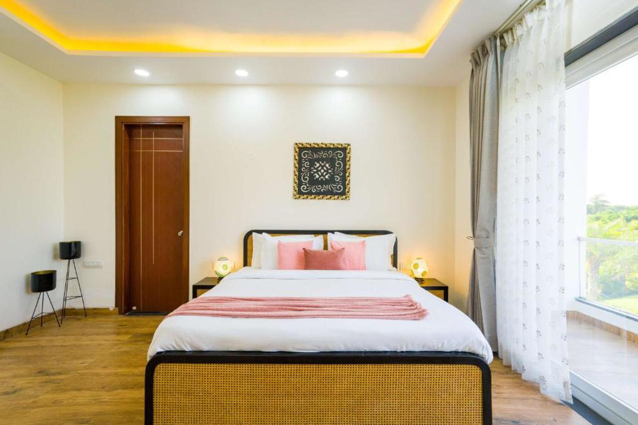 Room at ELIVAAS AdhiVa Retreat 5 BHK Farmhouse with Pvt Pool, Bar & Lush Garden, GURGAON