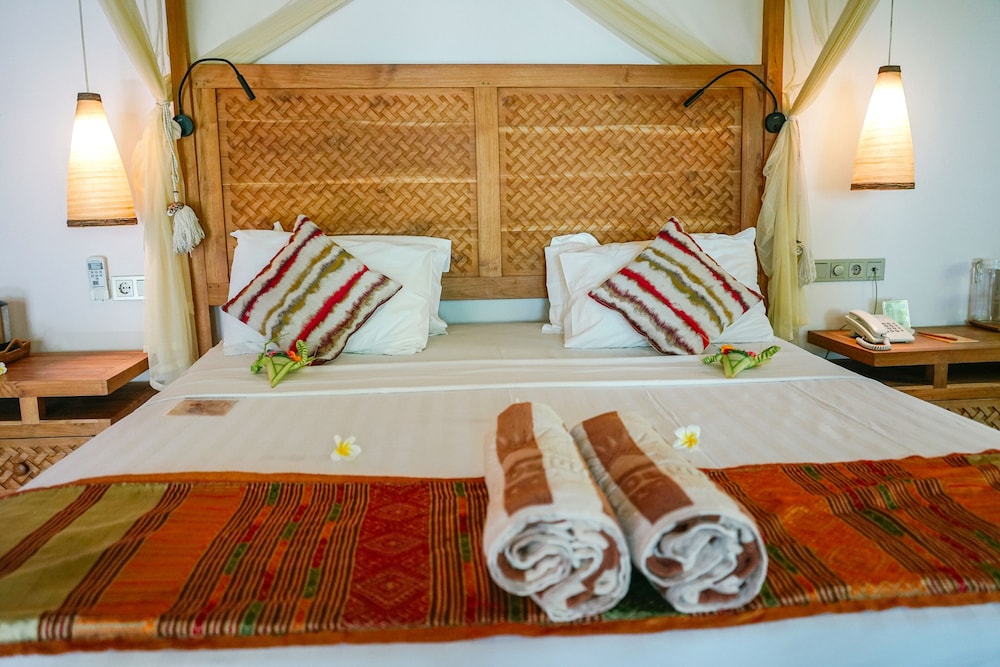 كوخ ديلوكس بسرير كينج بإطلالة على الحديقة، Puri Dajuma Beach Eco Resort & Spa 2/7