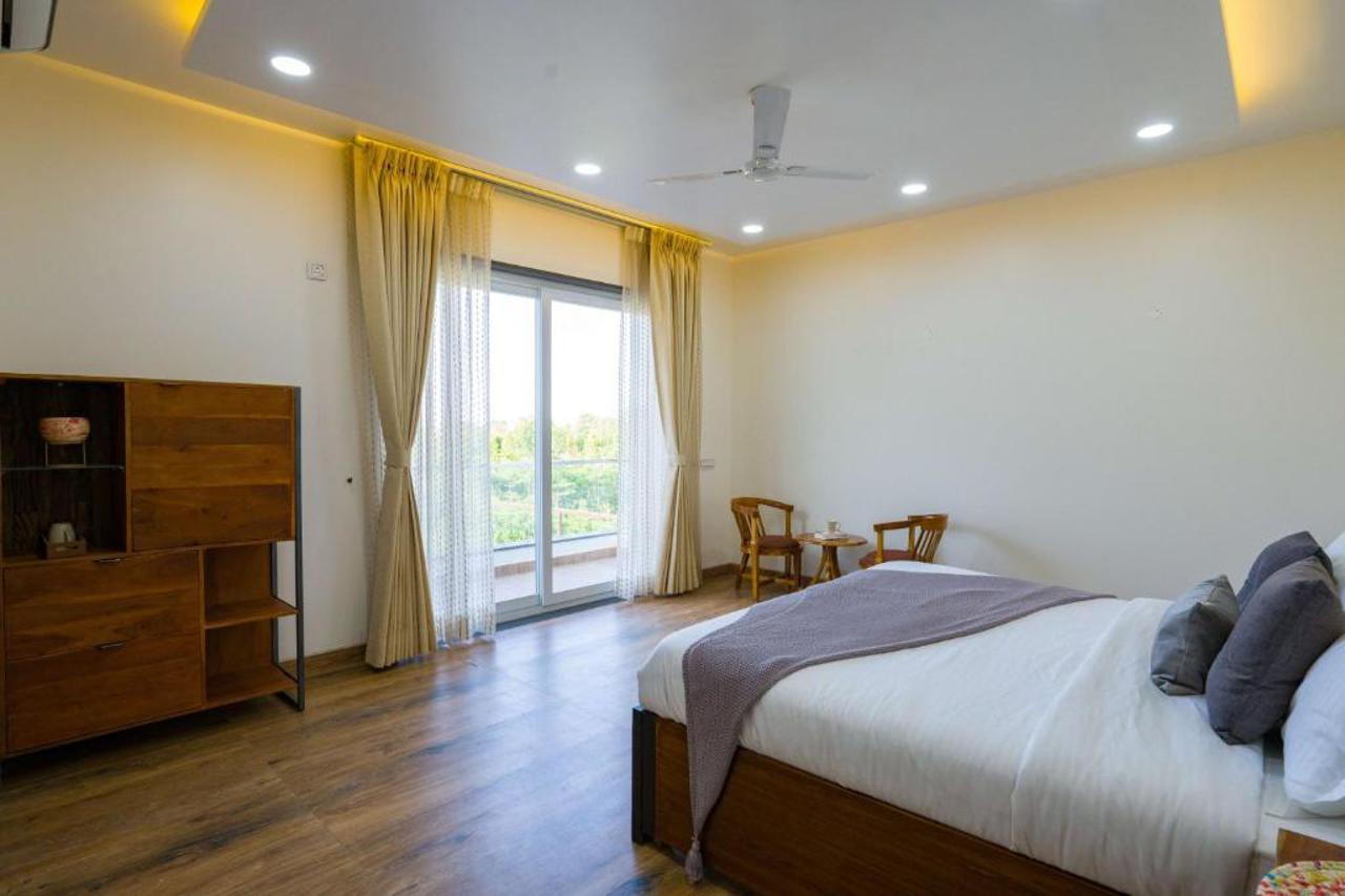 Room at ELIVAAS AdhiVa Retreat 5 BHK Farmhouse with Pvt Pool, Bar & Lush Garden, GURGAON