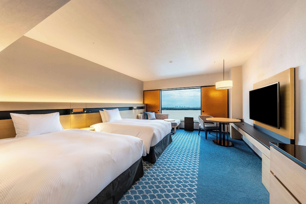 غرفة تنفيذية بسريرين منفصلين بإطلالة على البحر مع دخول الصالة