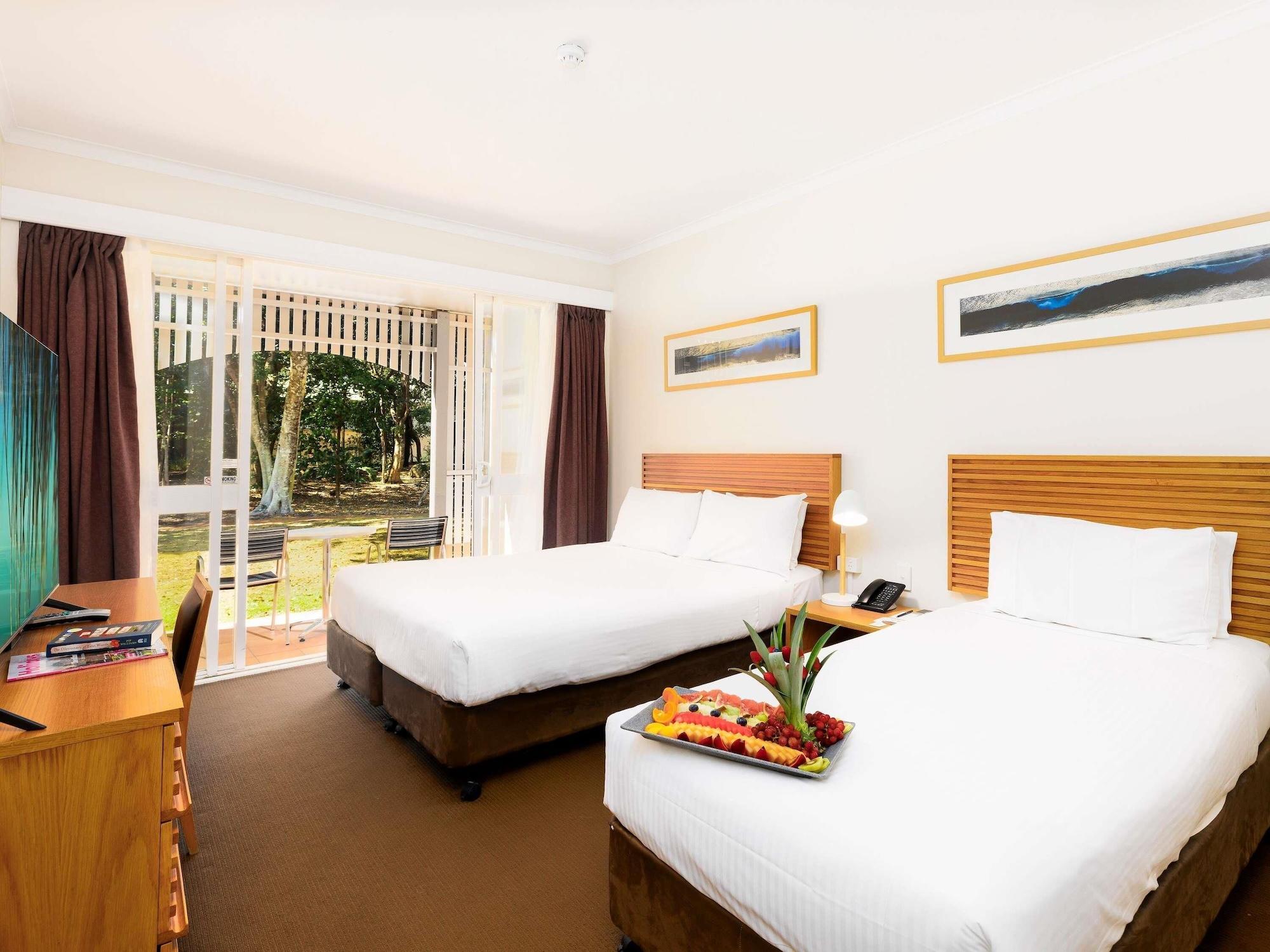 room, multiple beds, garden view