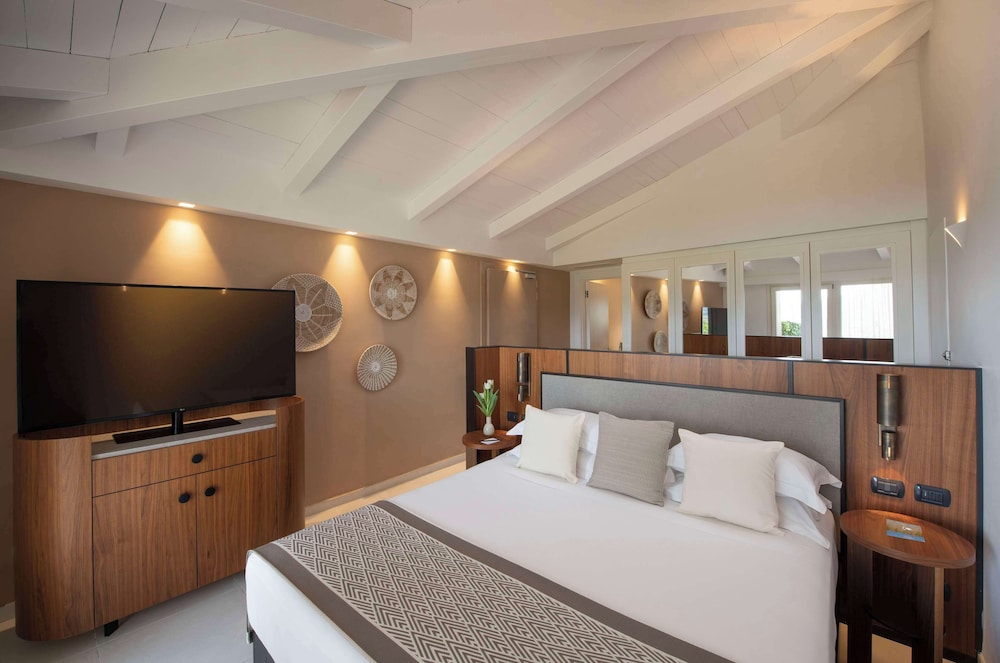 Room at Baia di Chia Resort Sardinia, Curio Collection by Hilton, DOMUS DE MARIA